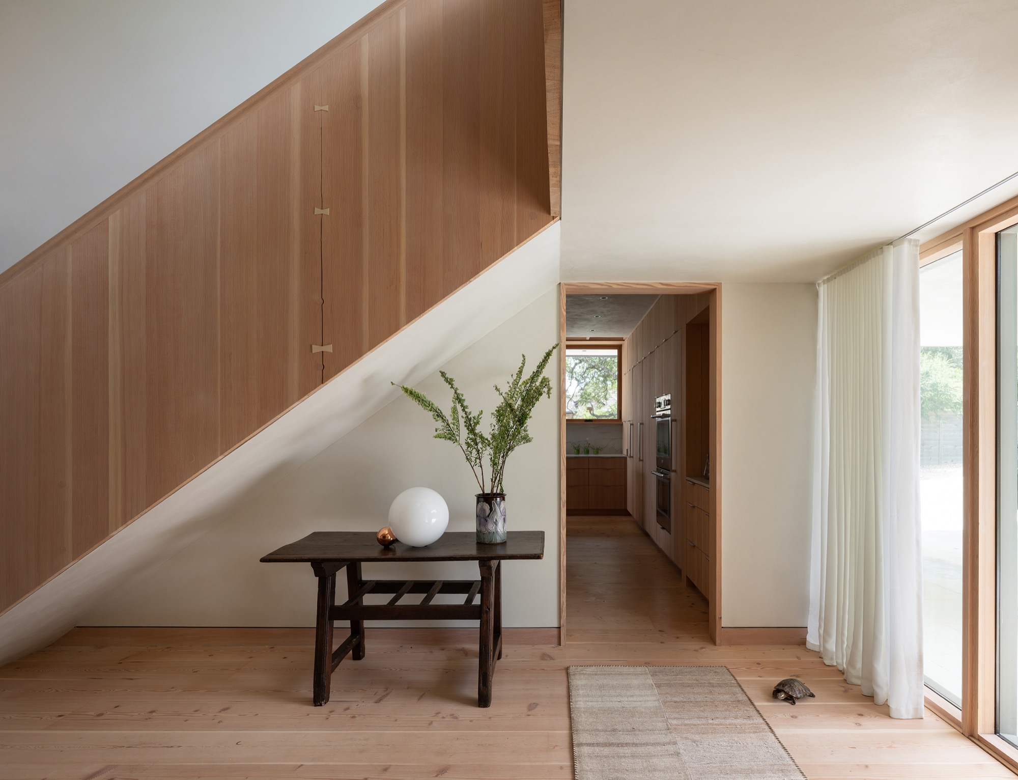 Hillside House Douglas fir stair and kitchen cabinetry in West Lake Hills, Texas